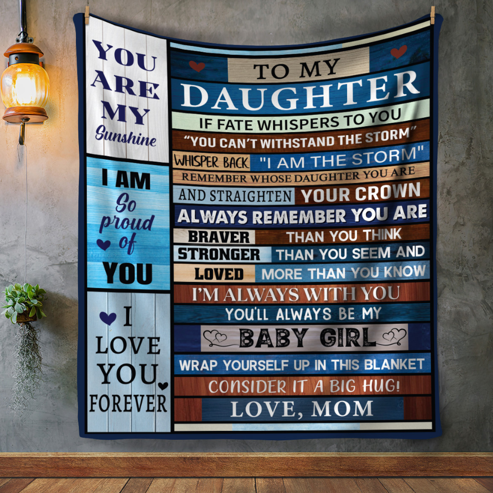 "Close-up of the inspirational message printed on the ‘To My Daughter’ blanket hung vertically on the wall."